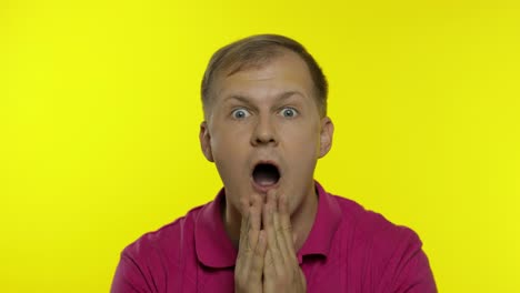 portrait of caucasian man posing in pink t-shirt. amazed handsome guy shocked, surprised, say wow