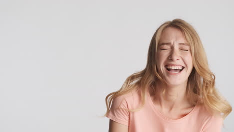 Caucasian-woman-showing-stop-gesture-while-laughing-on-camera.