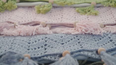 multicolored knitted blankets with tassels