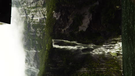 waterfalls forming everywhere during rain season in milford sound, vertical view