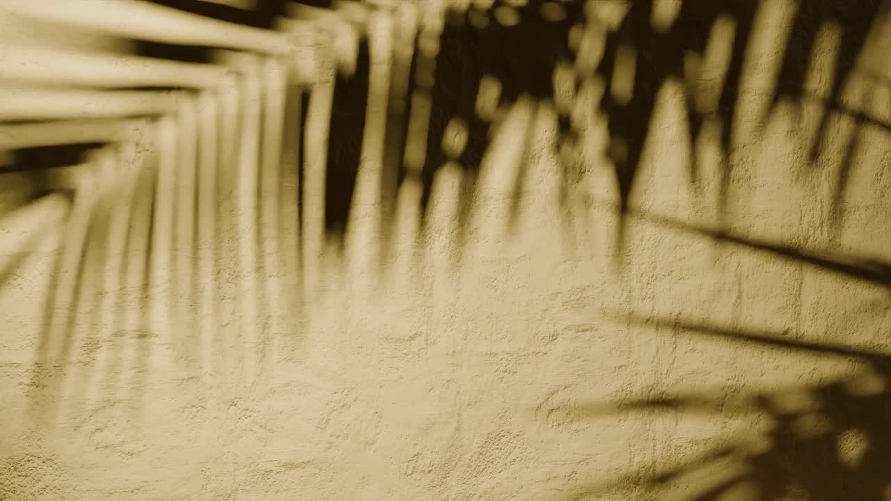 Shadow of palm leaves on textured yellow plaster wall with natural sunlight. Tropical plant silhouette on stucco surface. Design for wallpaper, banner, postcard, greeting card, poster, vertical