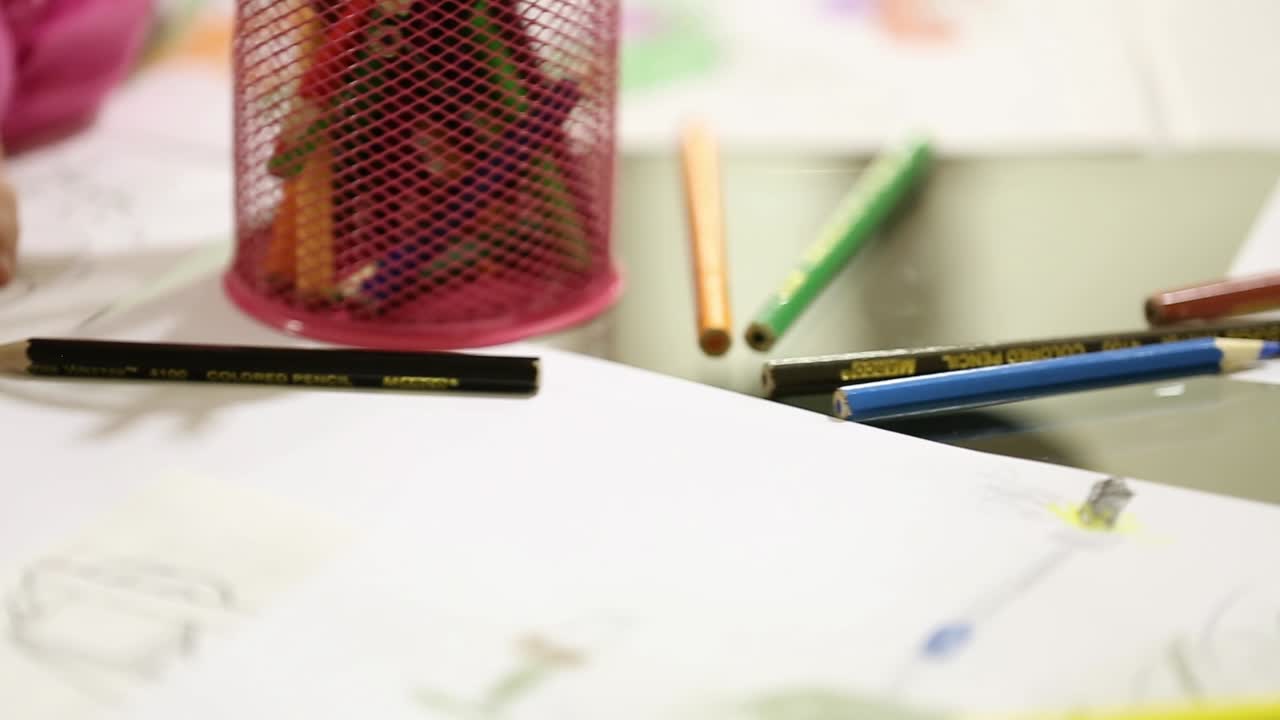 Children Paint Pencils. Preschool class drawing at table in classroom in playschool