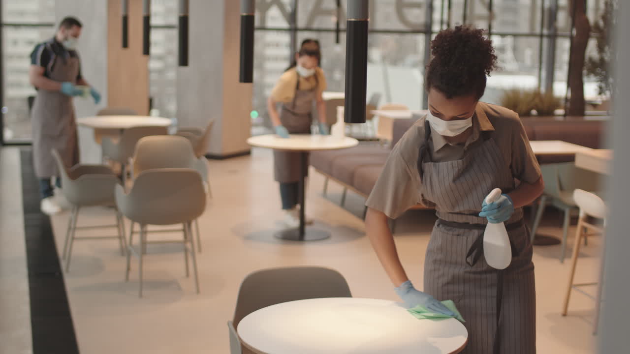 Waiters Cleaning in Restaurant Before Opening