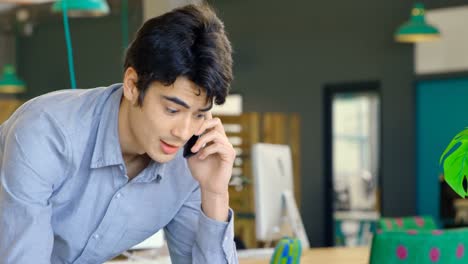 male executive talking on mobile phone in the office 4k