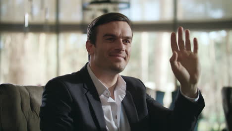 Business-man-greeting-friend-in-restaurant.-Man-calling-waiter-at-restaurant