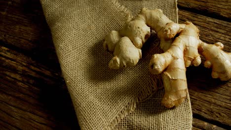 Ginger-with-textile-on-a-wooden-table-4k