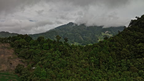 cerro punta panama aerial v1 flyover mountain ridge reveals cultivated farmland and stratovolcano volcan baru mountainscape with dense tropical clouds in the sky - shot with mavic 3 cine - april 2022