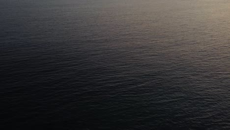 Arial-shot-of-an-ocean-surface-in-sunset