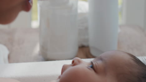 close up mother caring for baby on changing table happy mom playfully soothing toddler nurturing her child at home 4k footage