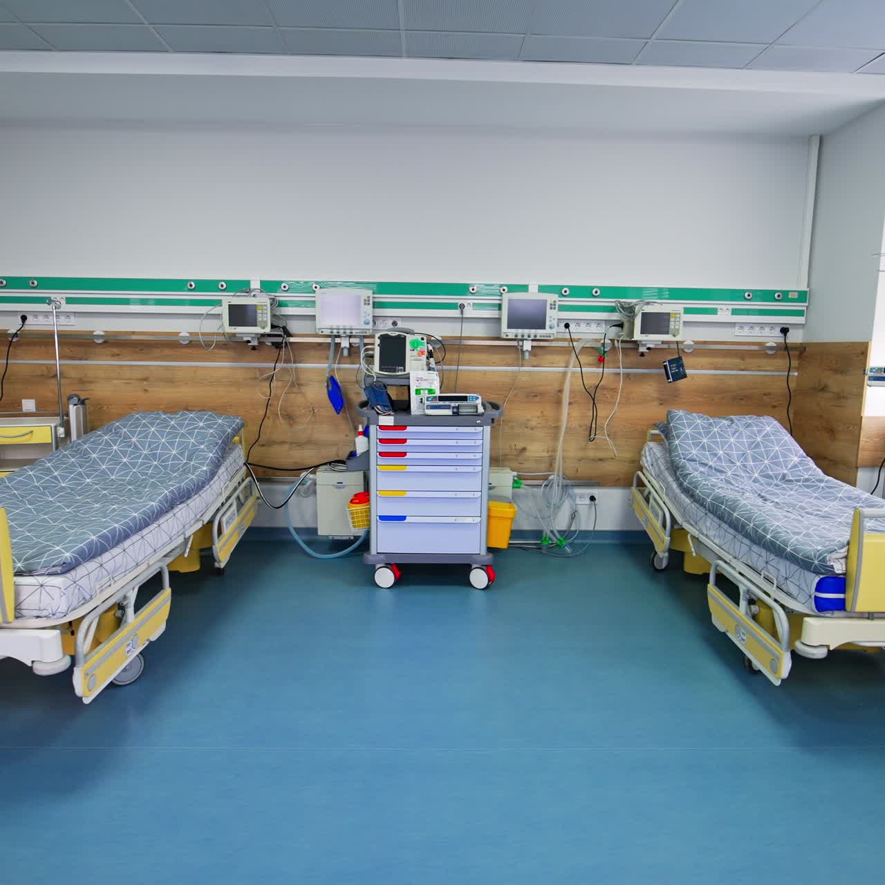 Big light ward with beds and equipment for reanimation. Two beds for intensive care patients in modern clinic