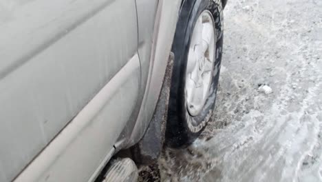 driving through a puddle in slow motion in winter snow conditions