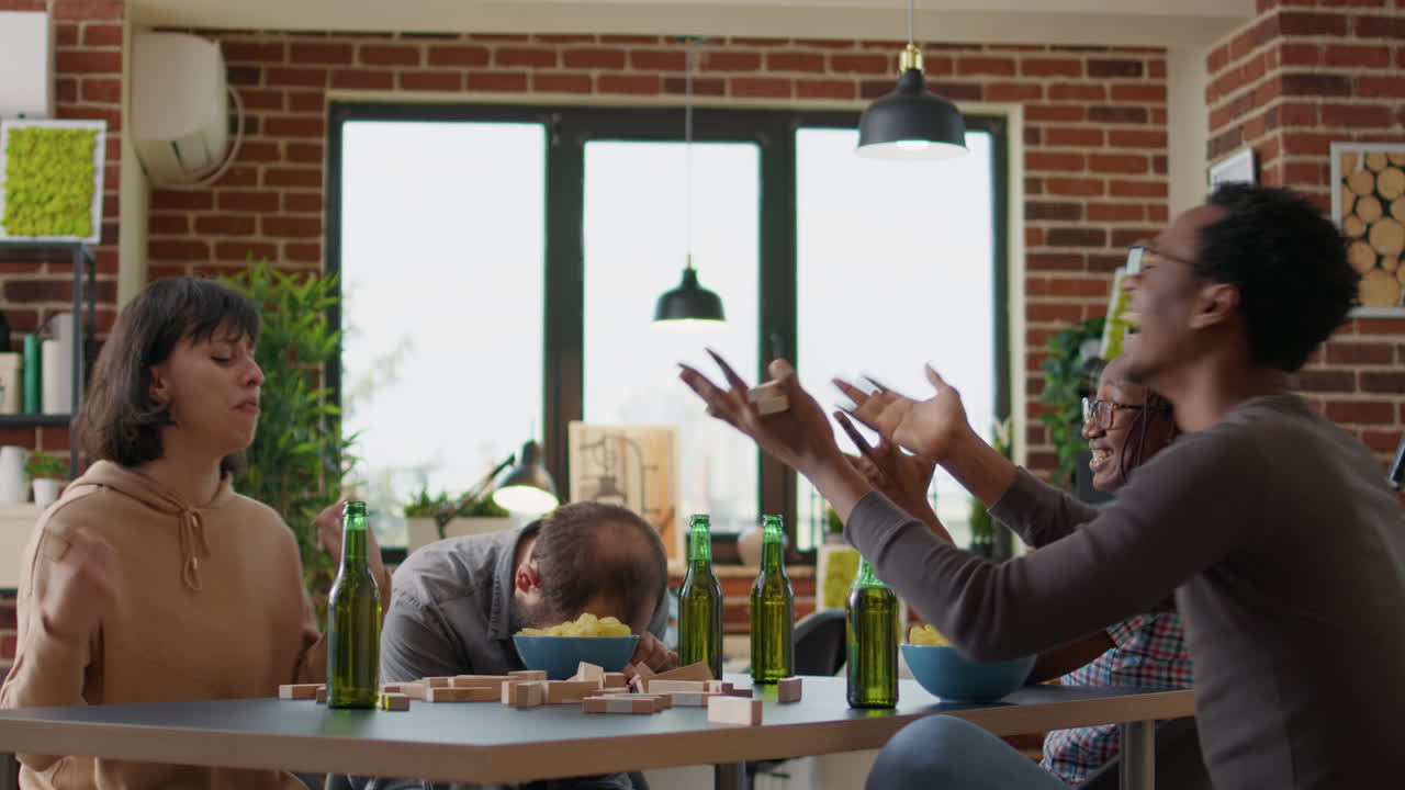 Competitive woman crashing blocks tower and losing game