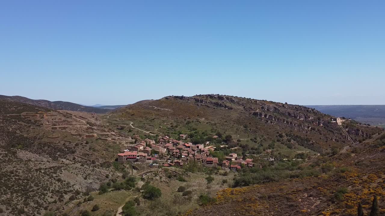 Beautiful landscape filmed with mini drone flying around a medieval village in Spain close to Madrid