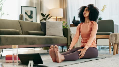 woman stretching on yoga mat at home