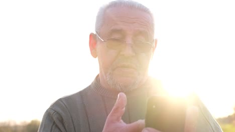 elderly man reacting with surprise to smartphone content