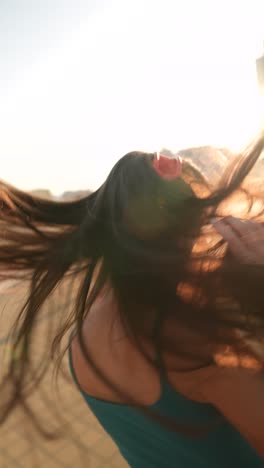 woman dancing outdoors with headphones