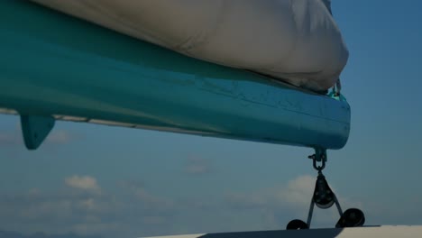 A-close-up-shot-of-a-mast-with-the-sail-lowered-moving-up-and-down-strongly