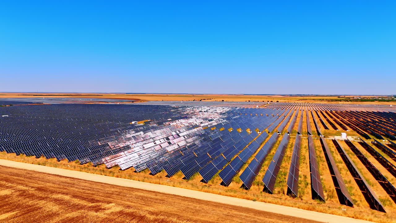 Expansive solar power farm in rural area. Solar panels spread across a rural landscape under clear blue skies, highlighting renewable energy in action