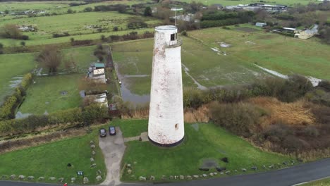 historic leasowe lighthouse maritime beacon landmark aerial coastal countryside wirral view pull back rising shot