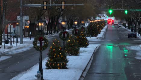 Aerial-view-of-Christmas-trees-and-wreaths-lining-main-street-in-a-small-town-in-America