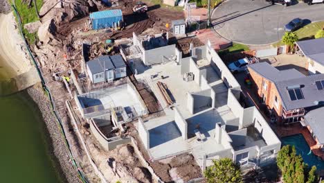 drone footage captures a construction site near a water canal in gold coast, australia, highlighting ongoing building activities