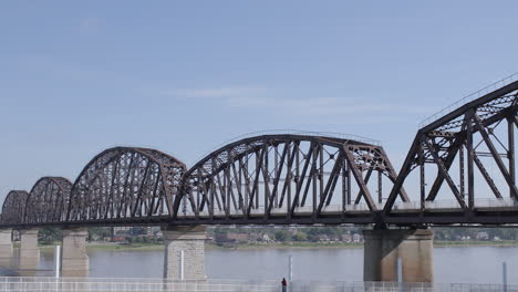 pan of the big four bridge in louisville kentucky with view of the ohio river and indiana on the other side