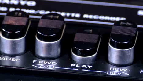 pushing play button on a vintage tape recorder