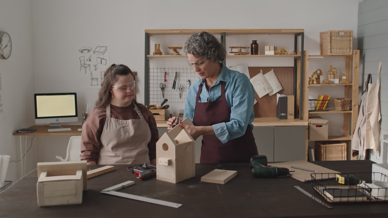 Woman with Down syndrome building a birdhouse