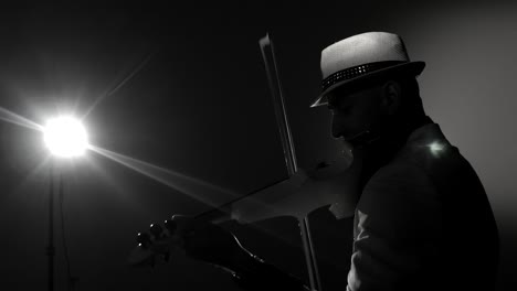 musician singing violinist playing violin instrument symphonic concert soloist. dedolight background