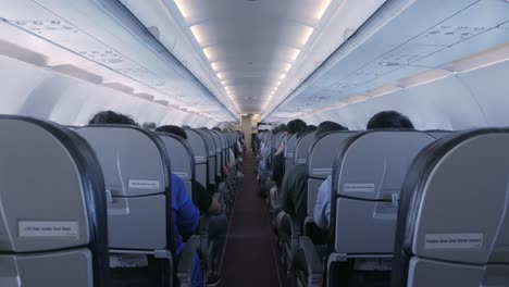 the-aisle-pathway-inside-plane-cabin-with-passenger