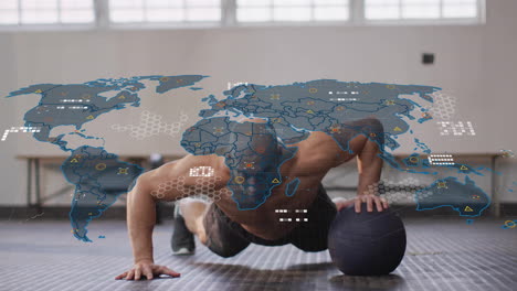Doing push-ups on medicine ball, man with animation of world map data overlay
