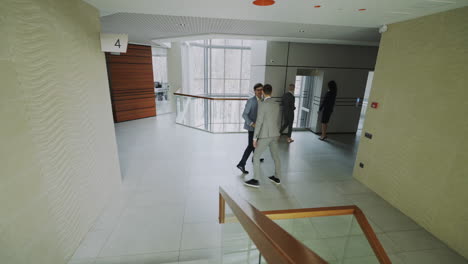 business people walking in modern office corridor