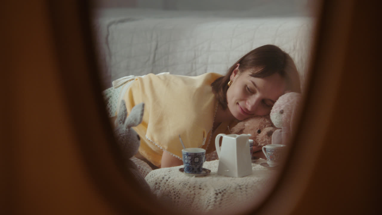 A girl playing with dolls in her room