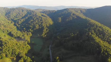 4K-Drone-Video-Flying-High-Above-Trees-Along-Mountain-Road-in-Smoky-Mountains-near-Asheville,-NC-on-Foggy-Morning