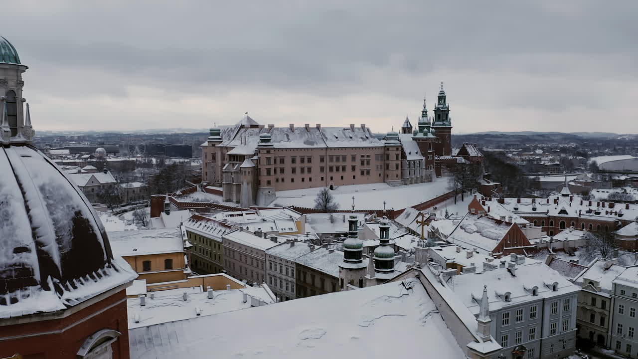 Aerial view of snow covered Old Town (Grodzka Street) with a view of Wawel Castle and Church of Saints Peter and Paul in Krakow, Poland