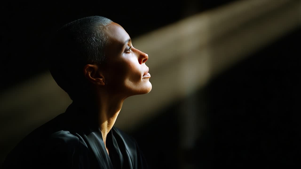 A Contemplative Moment in Shadows: Capturing the Essence of Serenity and Reflection in a Stark Contrast of Light and Darkness, Highlighting Quiet Strength and Inner Peace