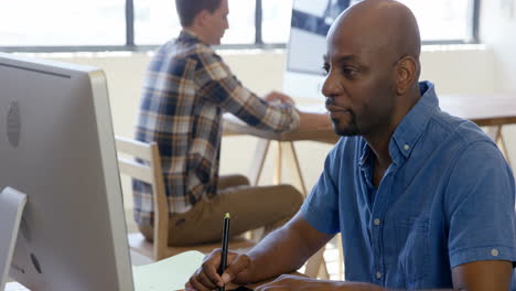 casual businessman using a graphic tablet