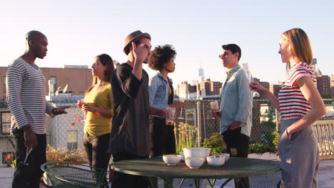 adult friends socialising on a new york rooftop