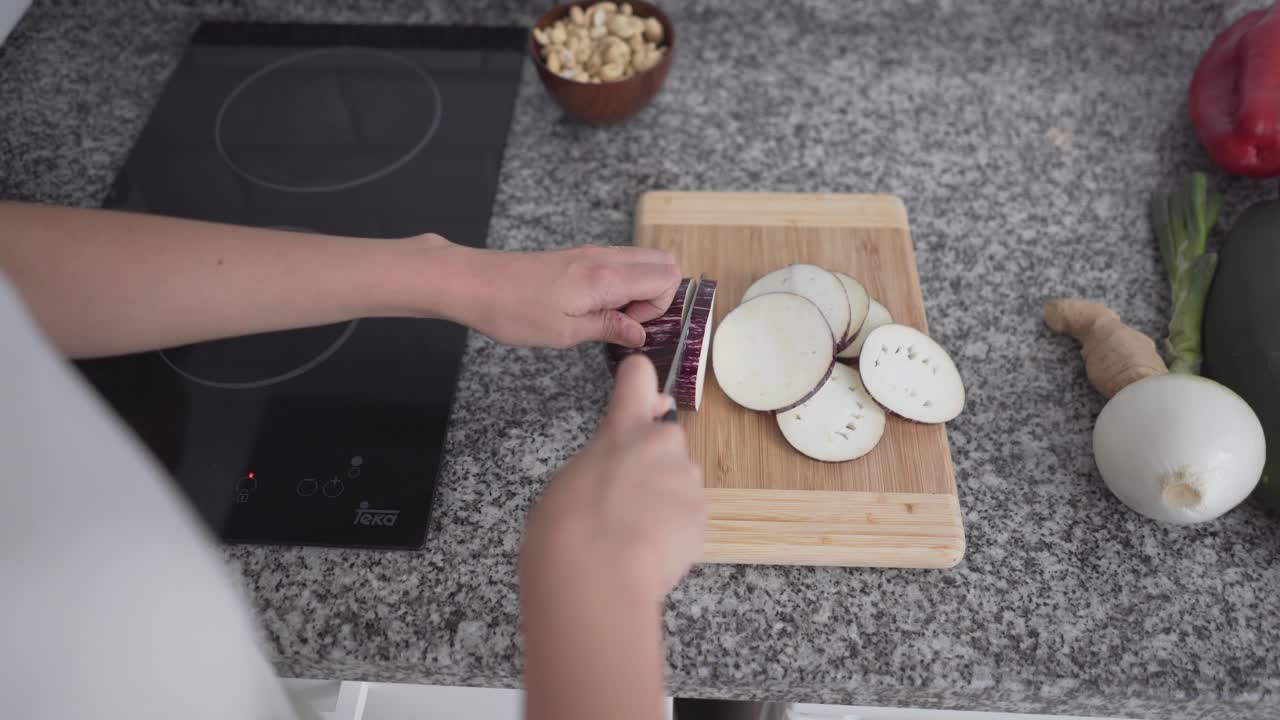 Woman Slicing Eggplant