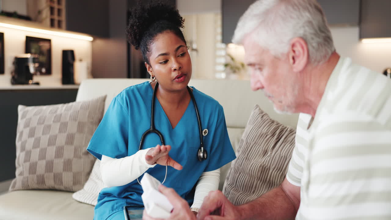 Nurse Explaining Medication to Senior Man During Home Visit