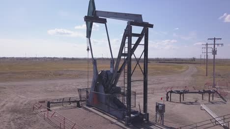 aerial orbits pumpjack nodding donkey pumping crude oil on plains