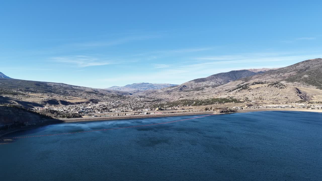 Curling drone shot of Silverthorne, Colorado from above the Dillon Reservoir-Dam