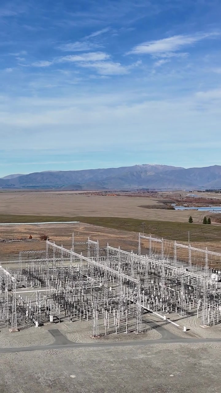Drone footage showing high-voltage power lines and electrical infrastructure in a rural landscape.