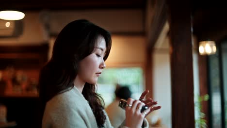 Woman taking photo in a cozy cafe