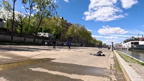 skateboarders practicing tricks near the river