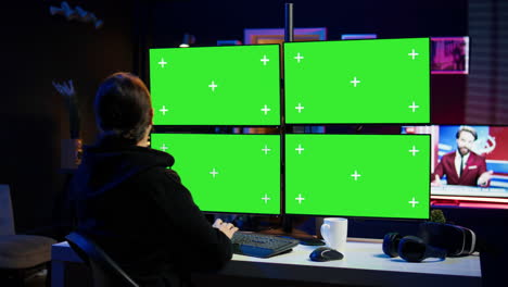 Cybercriminal coding on green screen monitors, developing zero day exploit