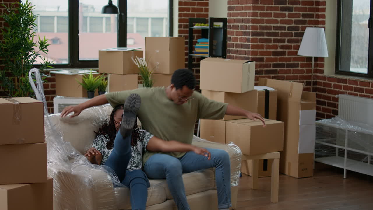 African american partners unpacking living room couch