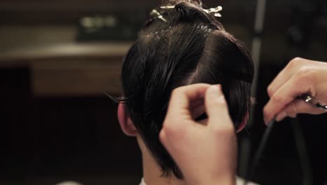 close-up-of-male-hands-of-a-master-cut-with-scissors-and-a-comb