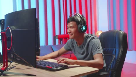 asian gamer man playing game