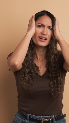 hispanic adult woman feeling sick with headache. vertical footage